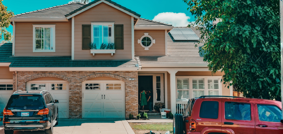 Home with 3 car garage with a merceds parked in the driveway